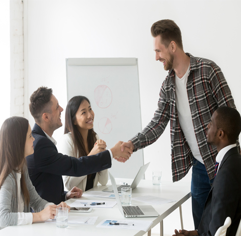 Team meeting handshake showing agreement and collaboration.