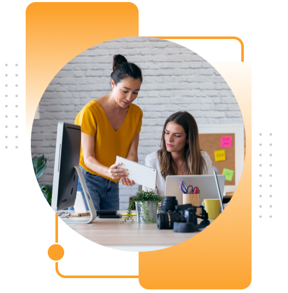 Two women working together in a modern office.